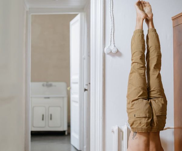 Man in deep concentration during a flexibility exercise in a calm environment.