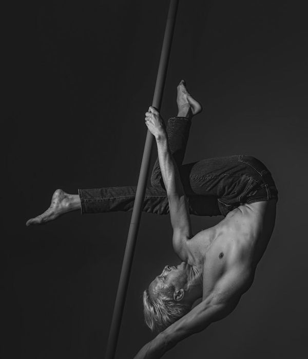 Man performing a controlled strength exercise in a minimalist gym setting.